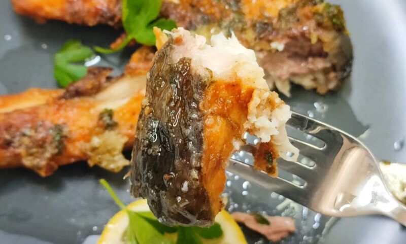 Fried silverfin on a fork, close up photo